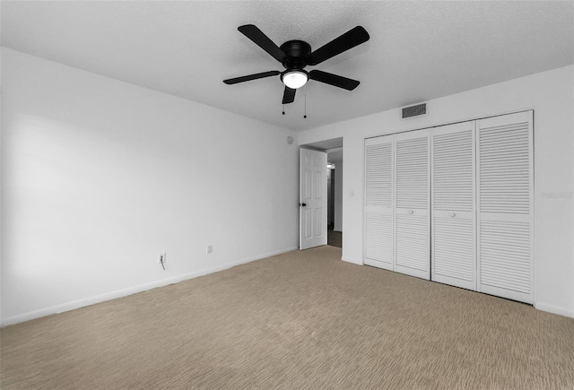 3021 Countryside Blvd Unit 28A, Clearwater, FL 33761 - unfurnished bedroom with light carpet, a closet, and a ceiling fan