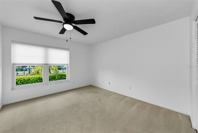 3021 Countryside Blvd Unit 28A, Clearwater, FL 33761 - spare room featuring carpet and a ceiling fan