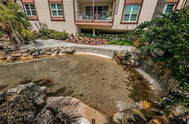 3021 Countryside Blvd Unit 28A, Clearwater, FL 33761 - view of yard featuring a balcony and a garden pond