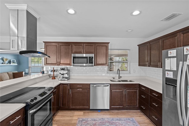 327 Sunny Ln, Belleair, FL 33756 - kitchen featuring stainless steel appliances, light countertops, light wood-type flooring, and recessed lighting