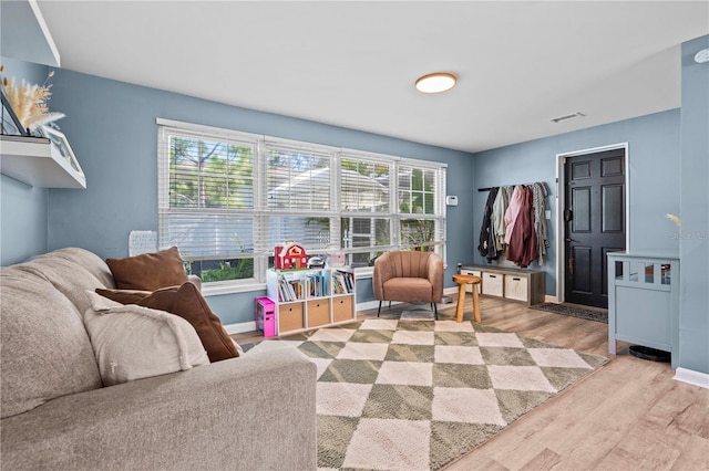 327 Sunny Ln, Belleair, FL 33756 - living room with wood finished floors and plenty of natural light
