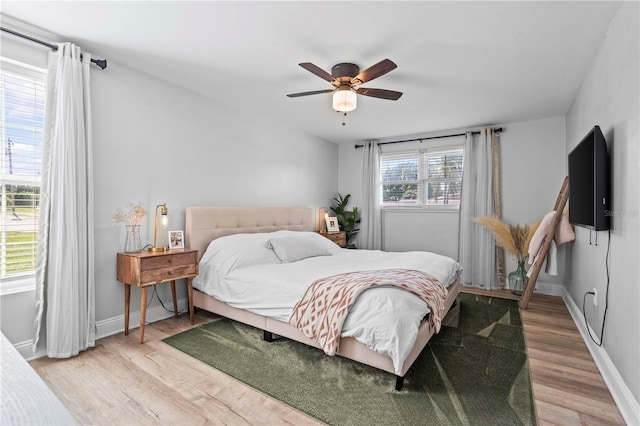 327 Sunny Ln, Belleair, FL 33756 - bedroom featuring light wood finished floors and a ceiling fan