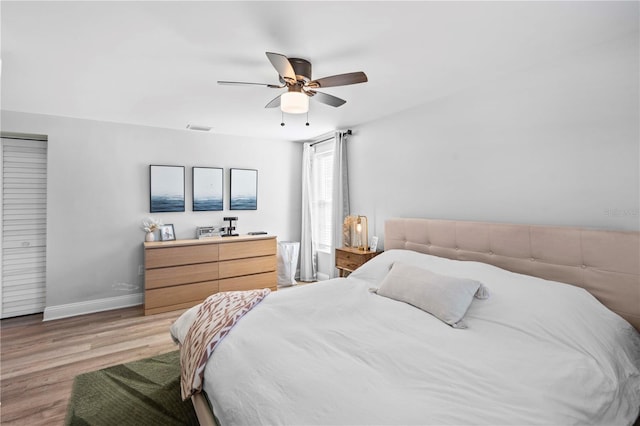 327 Sunny Ln, Belleair, FL 33756 - bedroom featuring light wood-style flooring and a ceiling fan