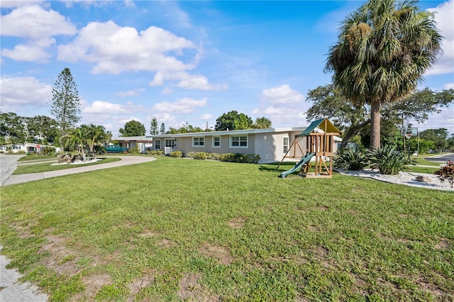 327 Sunny Ln, Belleair, FL 33756 - view of green lawn featuring a playground