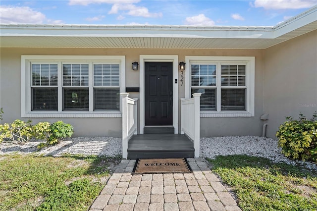 327 Sunny Ln, Belleair, FL 33756 - doorway to property with stucco siding