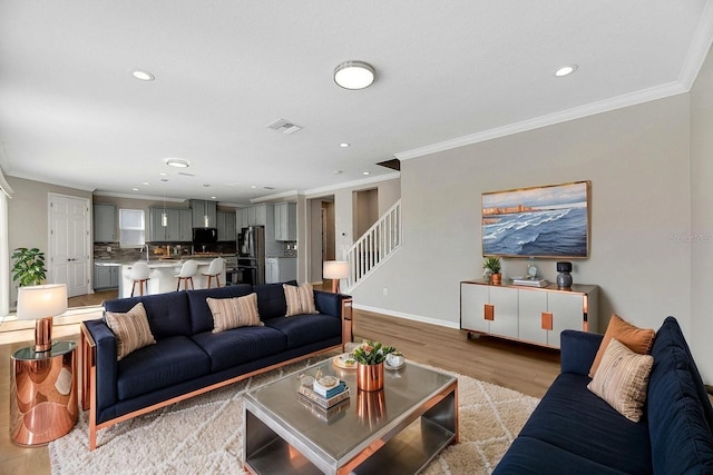 1192 Multiflora Loop, Lutz, FL 33558 - living area with crown molding, light wood-type flooring, stairway, and recessed lighting