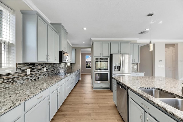 1192 Multiflora Loop, Lutz, FL 33558 - kitchen featuring stainless steel appliances, crown molding, gray cabinetry, backsplash, and recessed lighting