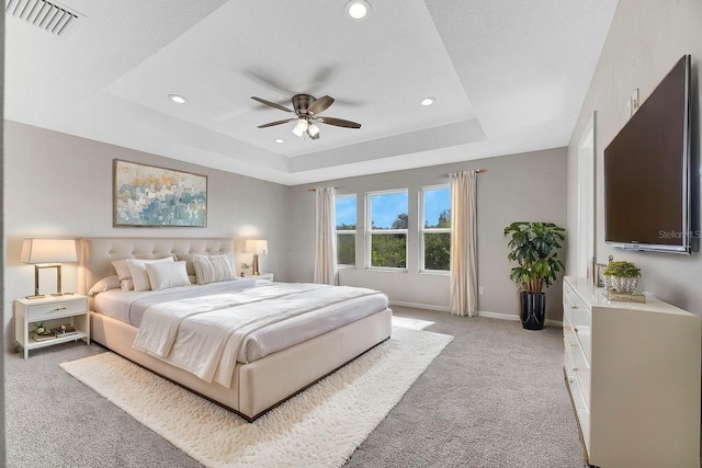 1192 Multiflora Loop, Lutz, FL 33558 - bedroom featuring light carpet, a raised ceiling, recessed lighting, and a ceiling fan