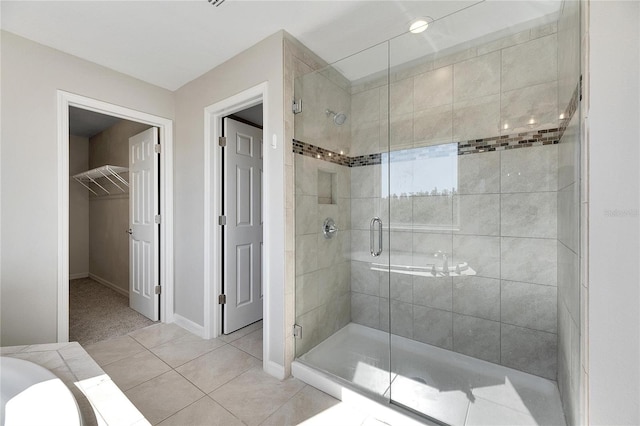 1192 Multiflora Loop, Lutz, FL 33558 - bathroom featuring a stall shower, a spacious closet, and tile patterned floors