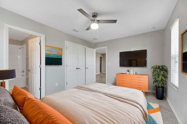 1192 Multiflora Loop, Lutz, FL 33558 - carpeted bedroom featuring multiple windows, a closet, a ceiling fan, and ensuite bath