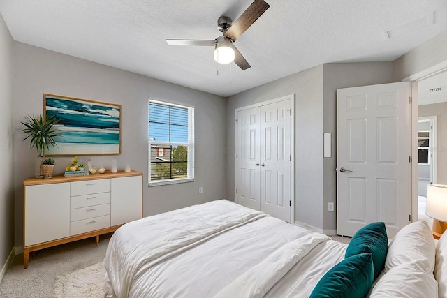 1192 Multiflora Loop, Lutz, FL 33558 - bedroom featuring light colored carpet, a closet, ceiling fan, and a textured ceiling