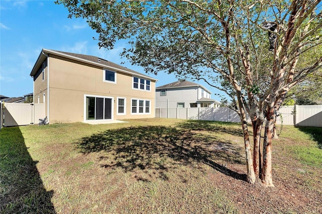 1192 Multiflora Loop, Lutz, FL 33558 - rear view of property with a fenced backyard and stucco siding
