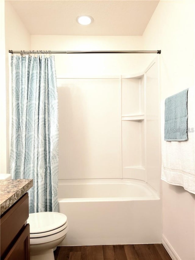 5578 Maggiore Blvd, Lakeland, FL 33805 - bathroom with vanity, shower / bath combo with shower curtain, and wood finished floors