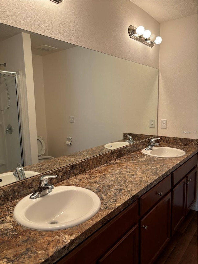 5578 Maggiore Blvd, Lakeland, FL 33805 - full bath featuring double vanity, a stall shower, wood finished floors, and a textured ceiling