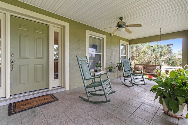 70 Arthur Ln, Winter Haven, FL 33880 - property entrance featuring a ceiling fan and stucco siding