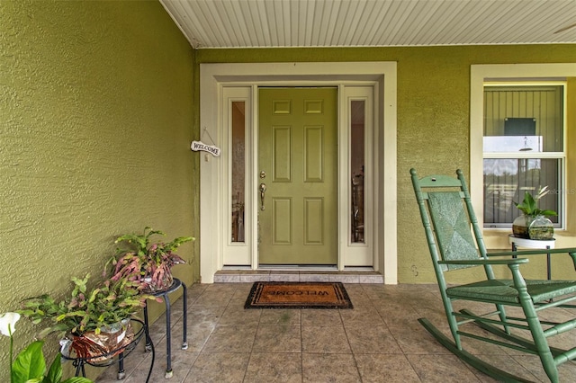 70 Arthur Ln, Winter Haven, FL 33880 - property entrance with stucco siding and covered porch