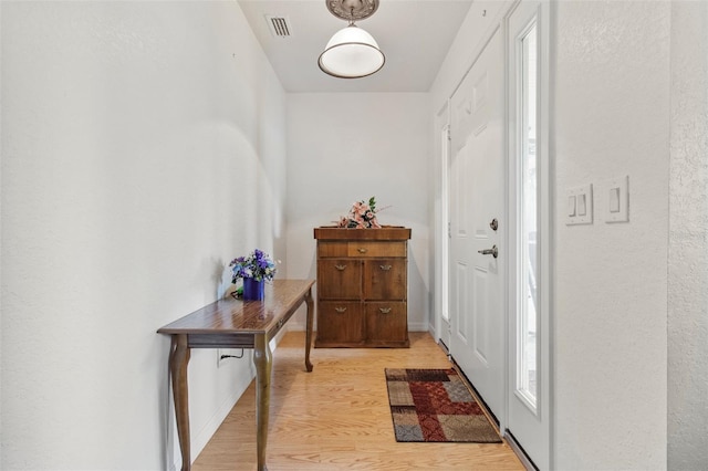 70 Arthur Ln, Winter Haven, FL 33880 - entryway with light wood-style floors and a textured wall