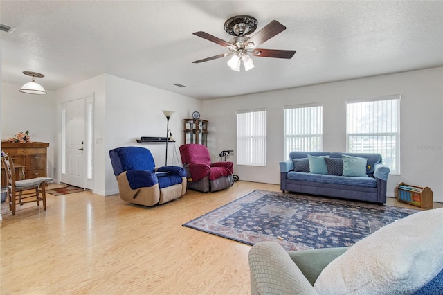 70 Arthur Ln, Winter Haven, FL 33880 - living area featuring wood finished floors, ceiling fan, and a textured ceiling