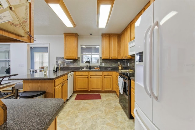 70 Arthur Ln, Winter Haven, FL 33880 - kitchen featuring white appliances, a peninsula, decorative backsplash, and healthy amount of natural light