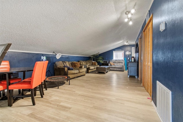 70 Arthur Ln, Winter Haven, FL 33880 - living room featuring a textured ceiling, light wood-style floors, and lofted ceiling