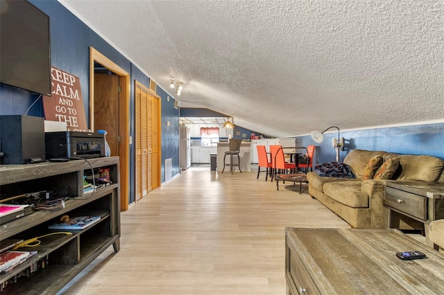 70 Arthur Ln, Winter Haven, FL 33880 - living room featuring a textured ceiling, vaulted ceiling, and wood finished floors