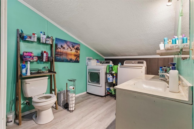 70 Arthur Ln, Winter Haven, FL 33880 - laundry area with independent washer and dryer, a textured ceiling, and light wood-style flooring