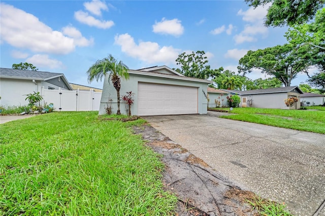 12402 84th Way, Largo, FL 33773 - view of front of house featuring driveway, stucco siding, a gate, and a garage