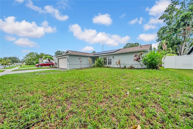 12402 84th Way, Largo, FL 33773 - view of front of property with a garage, stucco siding, solar panels, and concrete driveway