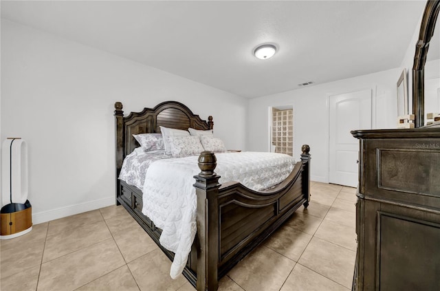 12402 84th Way, Largo, FL 33773 - bedroom with light tile patterned floors and baseboards