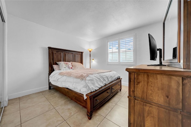 12402 84th Way, Largo, FL 33773 - bedroom with light tile patterned flooring and a textured ceiling