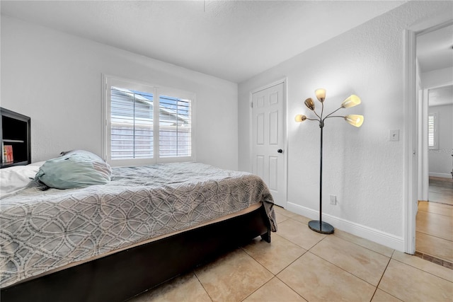 12402 84th Way, Largo, FL 33773 - bedroom featuring light tile patterned floors and baseboards