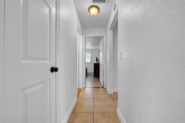 12402 84th Way, Largo, FL 33773 - hallway with a textured wall and light tile patterned flooring