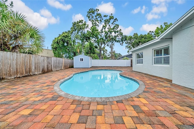 12402 84th Way, Largo, FL 33773 - view of swimming pool featuring a fenced backyard, a storage unit, and a patio area