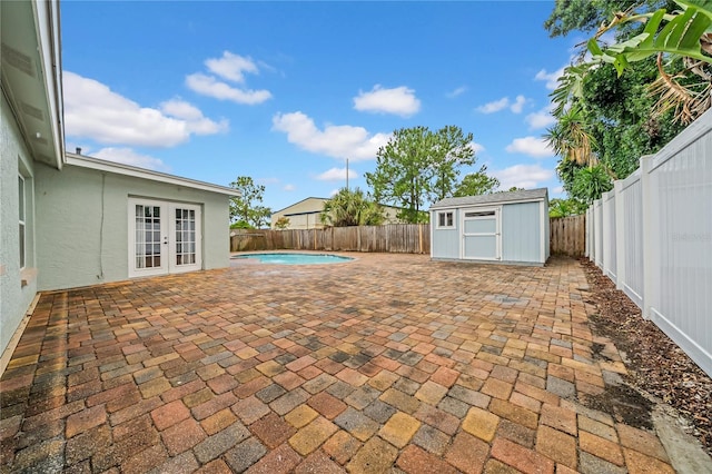 12402 84th Way, Largo, FL 33773 - fenced backyard featuring french doors, a patio, and a storage unit