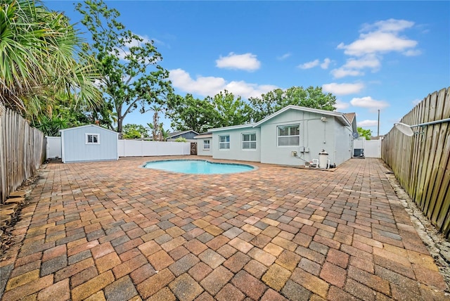 12402 84th Way, Largo, FL 33773 - view of pool with a patio, a shed, and a fenced backyard