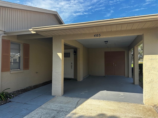 405 Gladstone Pl Unit 0, Sun City Center, FL 33573 - property entrance featuring stucco siding and driveway