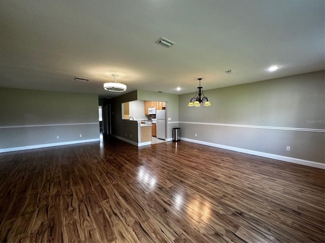 405 Gladstone Pl Unit 0, Sun City Center, FL 33573 - unfurnished living room with a chandelier and dark wood-type flooring