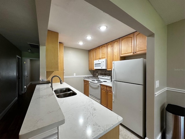 405 Gladstone Pl Unit 0, Sun City Center, FL 33573 - kitchen featuring white appliances, tasteful backsplash, recessed lighting, and a peninsula