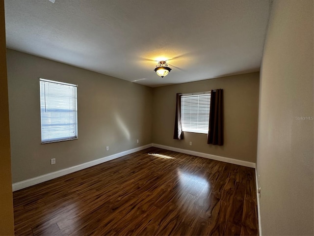 405 Gladstone Pl Unit 0, Sun City Center, FL 33573 - spare room with baseboards and dark wood finished floors