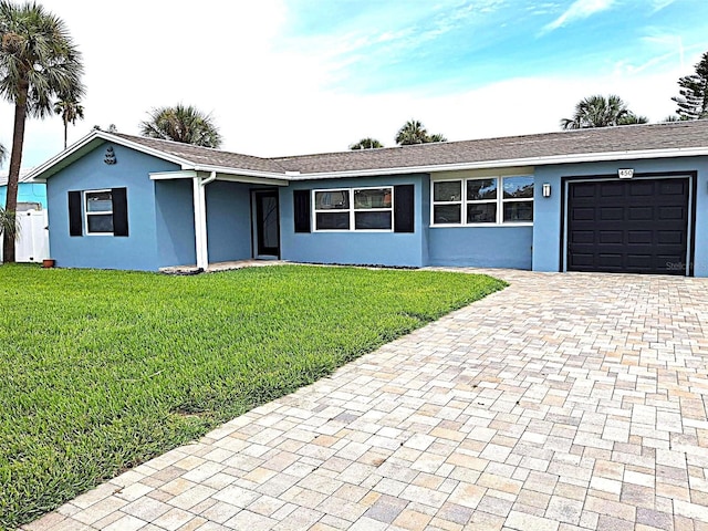 450 82nd Ave, St Pete Beach, FL 33706 - single story home featuring a garage, decorative driveway, stucco siding, and a front yard