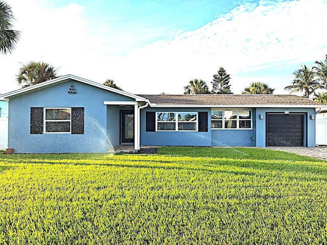 450 82nd Ave, St Pete Beach, FL 33706 - single story home with a garage, stucco siding, a front yard, and driveway