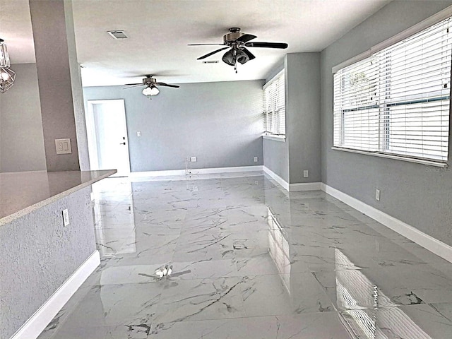 450 82nd Ave, St Pete Beach, FL 33706 - unfurnished living room with marble finish flooring and a ceiling fan