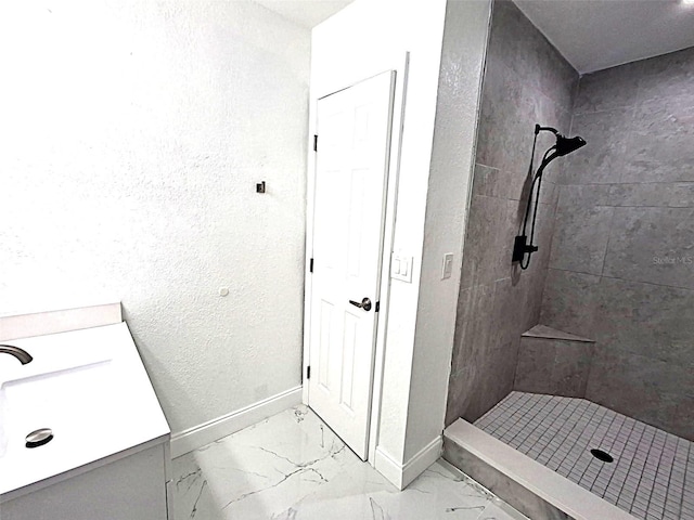 450 82nd Ave, St Pete Beach, FL 33706 - bathroom featuring a shower stall, vanity, and marble finish flooring