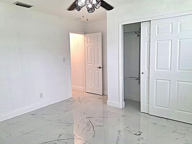 450 82nd Ave, St Pete Beach, FL 33706 - unfurnished bedroom featuring light marble finish flooring, a closet, and a ceiling fan