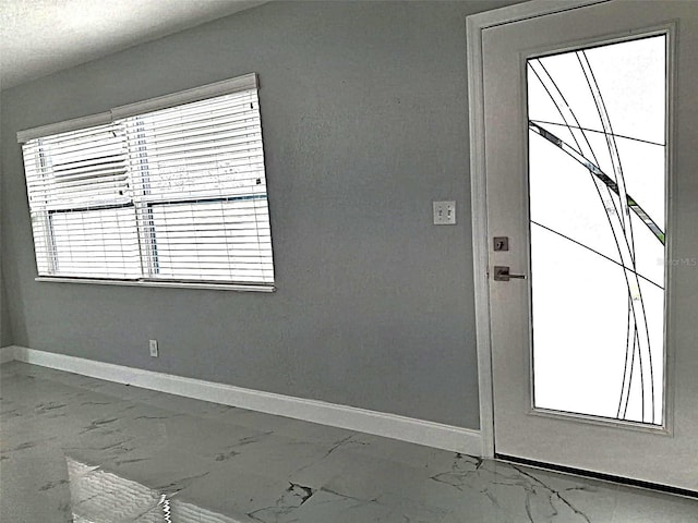 450 82nd Ave, St Pete Beach, FL 33706 - doorway to outside featuring marble finish flooring and baseboards