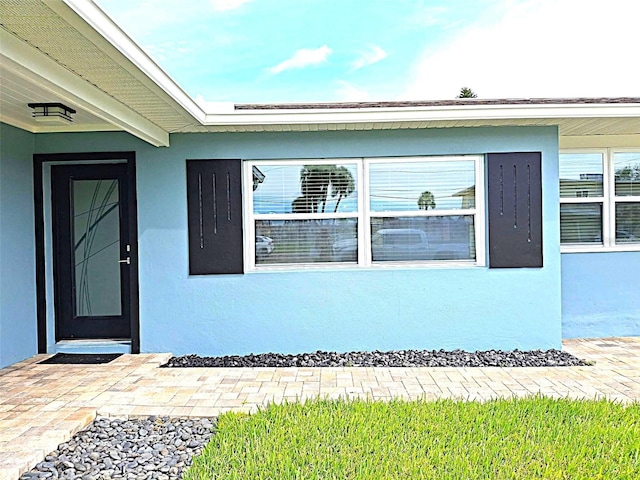 450 82nd Ave, St Pete Beach, FL 33706 - view of exterior entry featuring stucco siding