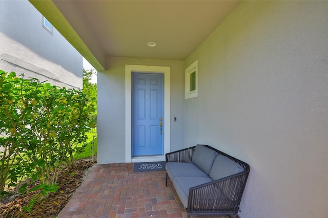 6215 Voyagers Pl, Apollo Beach, FL 33572 - entrance to property with stucco siding and an outdoor living space