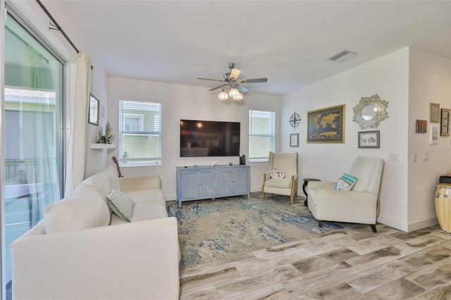 6215 Voyagers Pl, Apollo Beach, FL 33572 - living area featuring plenty of natural light, wood finished floors, and a ceiling fan