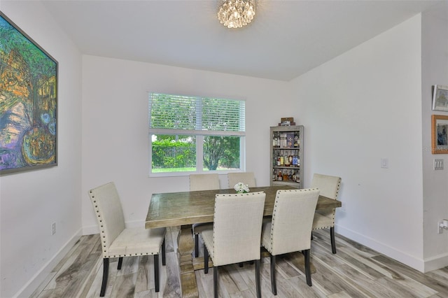 6215 Voyagers Pl, Apollo Beach, FL 33572 - dining area with wood finished floors and a chandelier