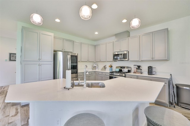 6215 Voyagers Pl, Apollo Beach, FL 33572 - kitchen featuring stainless steel appliances, a breakfast bar area, light countertops, recessed lighting, and pendant lighting